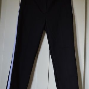 Black pants with white stripes.